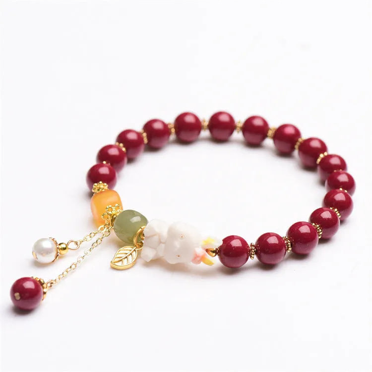 Natural cinnabar bracelet with rabbit charm for women, shown in 8mm and 10mm bead size options.