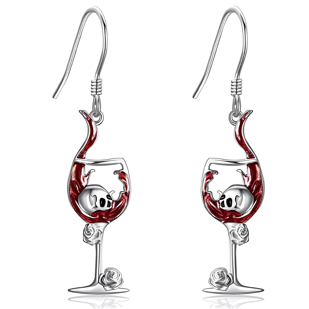 A pair of silver-toned zinc alloy earrings shaped like wine glasses adorned with skull details, on a plain background.