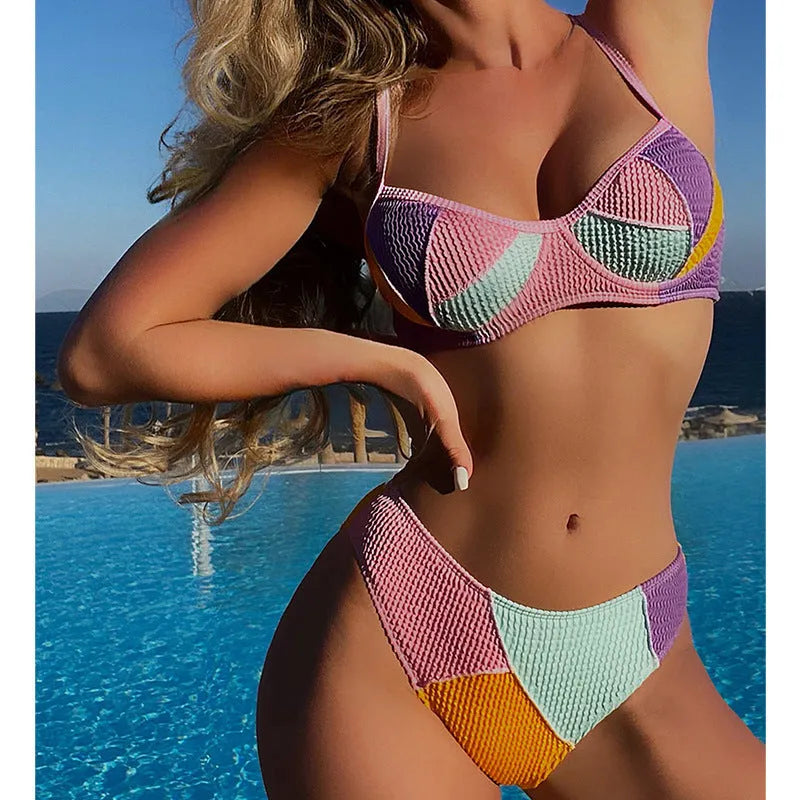 Ladies sleeveless push-up bikini set with steel bracket cups and crossover back stitching in a splicing colour pattern.
