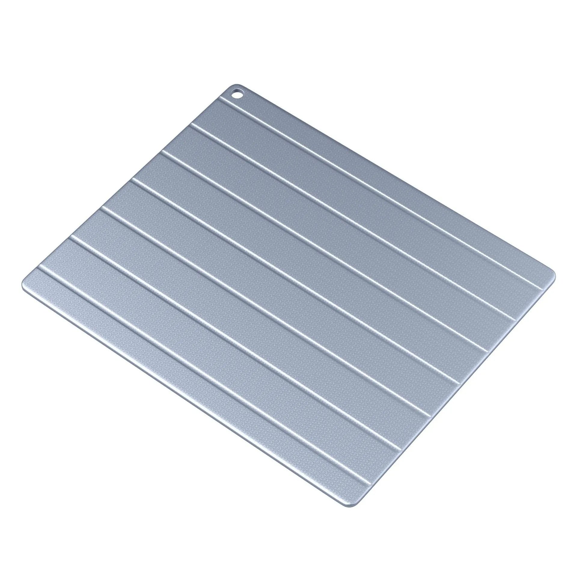 Aluminium household quick defrosting plate on a kitchen countertop with a USB cable.