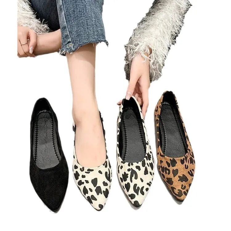 Women's leopard print flat pointed toe pumps with low heel on beige background