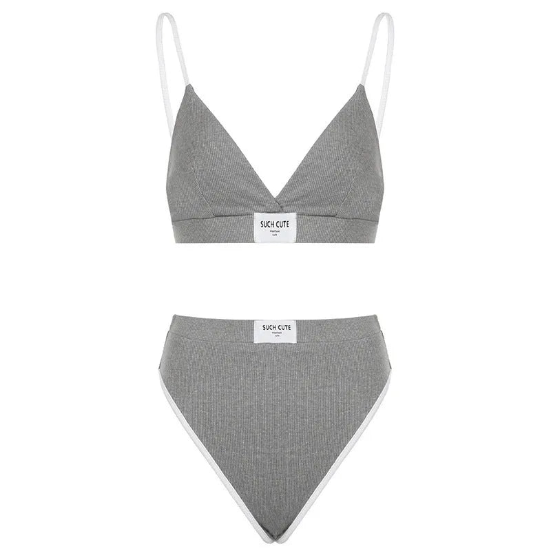Ladies black bikini set with white contrast embroidery binding on sleeveless top and shorts.