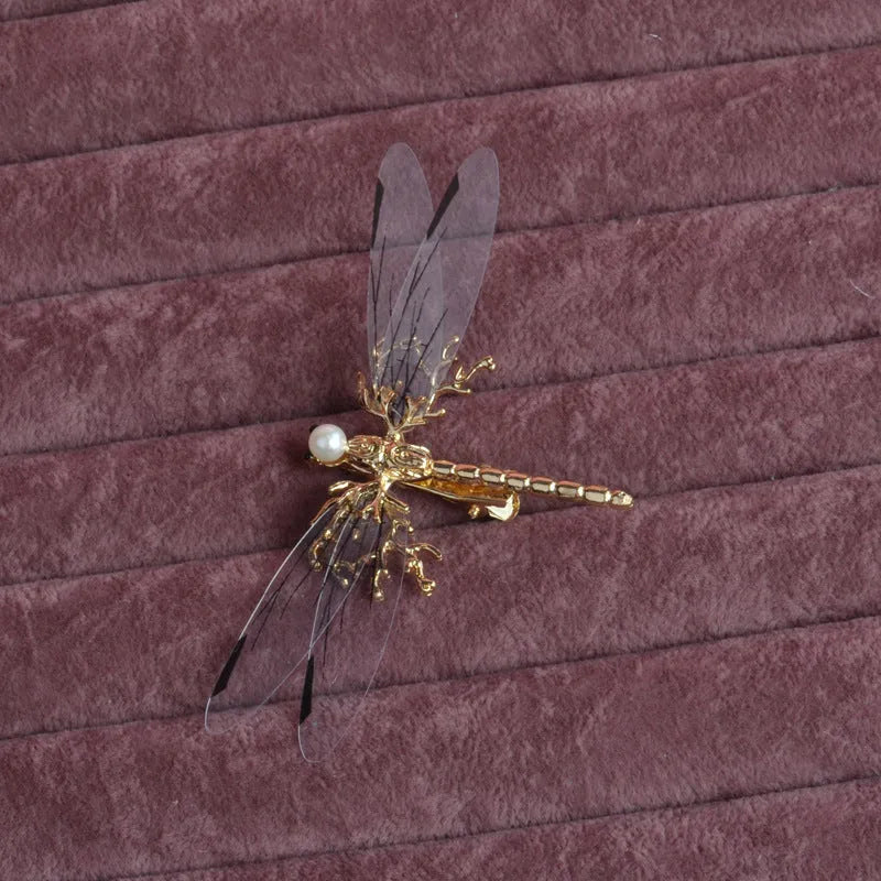 Golden electroplated alloy dragonfly side clip headdress for women.