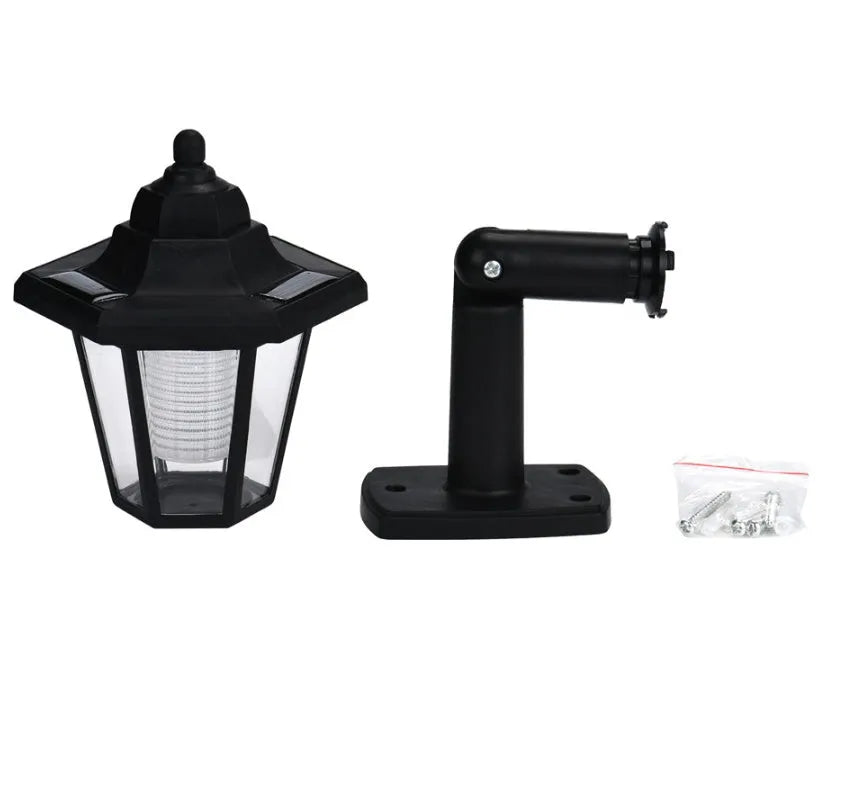 Black hexagonal solar wall lamp with solar panel and LED light for outdoor installation