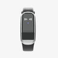 Black and white ultrasonic mosquito repellent bracelet on a wrist, showing compact design with USB charging port.