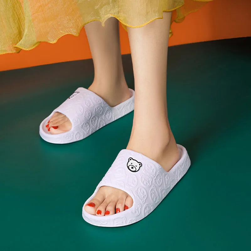 Pair of cute bear EVA indoor slippers in pink with thick non-slip soles.