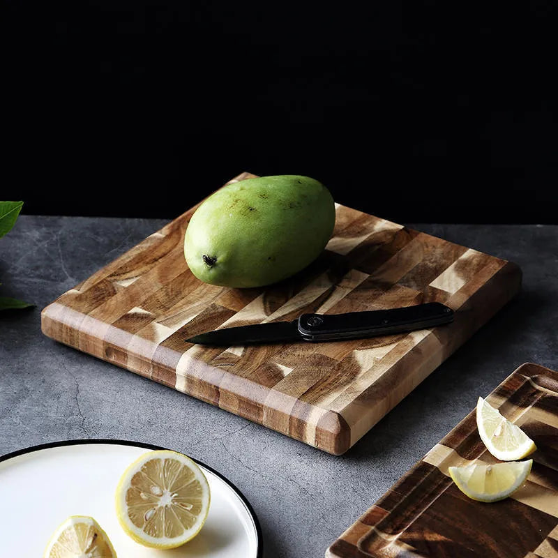Brown solid acacia wood chopping board, 3cm thick, on a kitchen countertop.