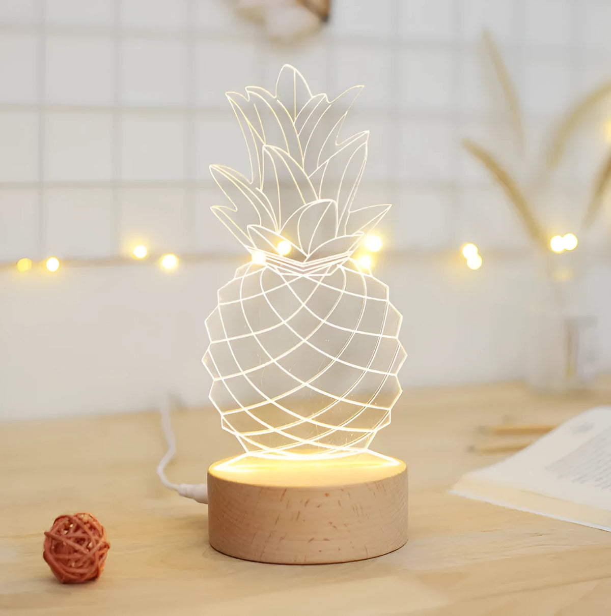 Wood and acrylic pineapple-shaped bedside table lamp with a dimmer switch and USB cable.
