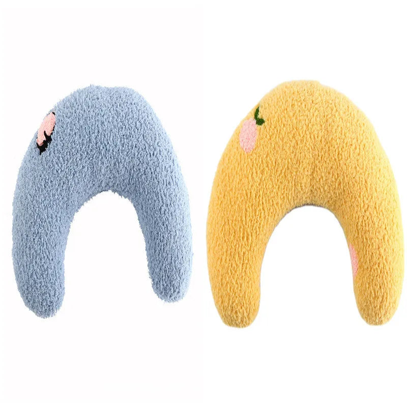 Small blue half-donut shaped pet pillow bed for cats or small dogs on a carpet.