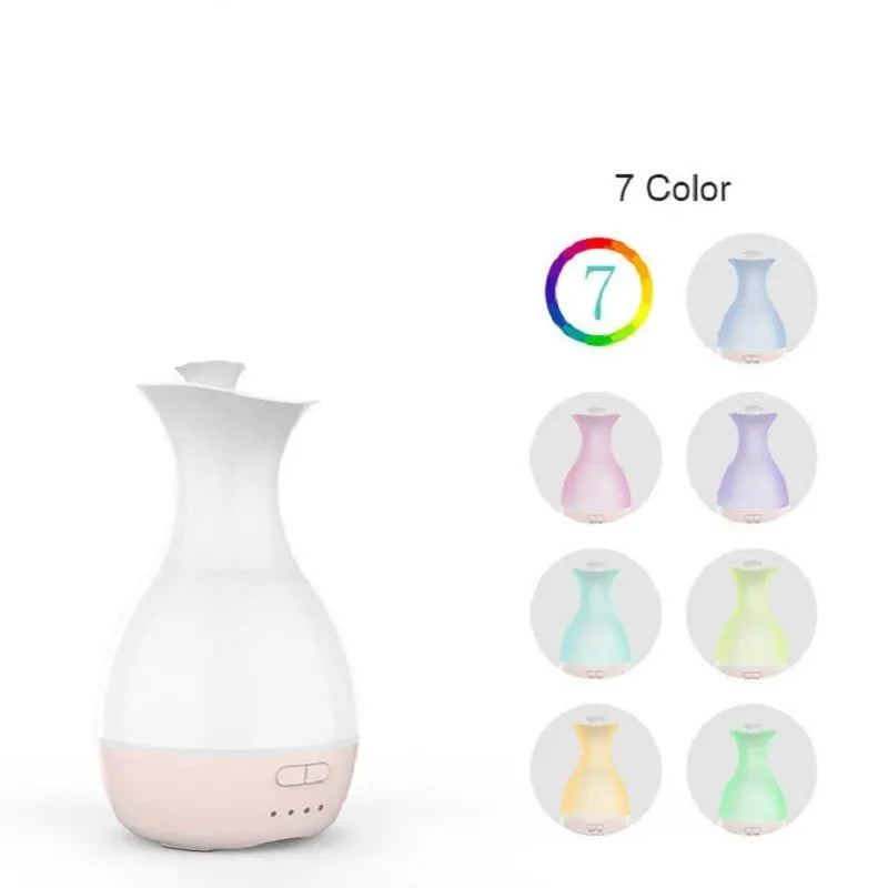 White or pink ceramic ultrasonic air humidifier and essential oil diffuser with colourful night light, 200ml capacity.