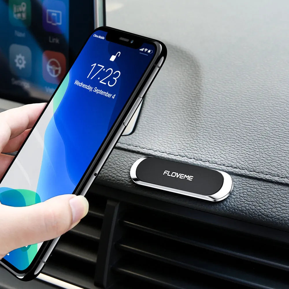Black magnetic car phone holder with adhesive base showing square silver iron plate and foam glue backing