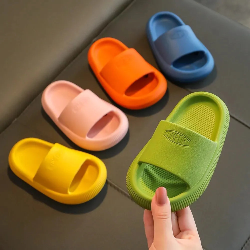 Children's bright coloured EVA slippers with textured non-slip soles, shown in blue, green, orange, pink, and yellow.