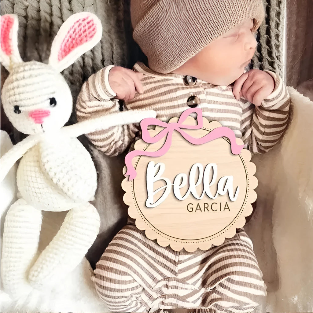 Square wooden baby ornament personalised with a custom name for nursery decor.