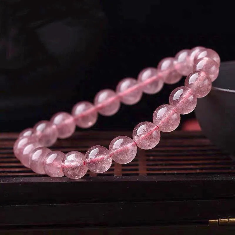 Women's strawberry quartz crystal bracelet with polished beads in 6mm, 8mm, or 10mm sizes