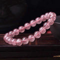 Women's strawberry quartz crystal bracelet with polished beads in 6mm, 8mm, or 10mm sizes