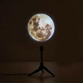 USB-powered Earth and Moon projection lamp with flexible hose bracket on a wooden table.