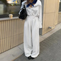 White striped wide-leg commuting trousers with zipper detailing on hanger