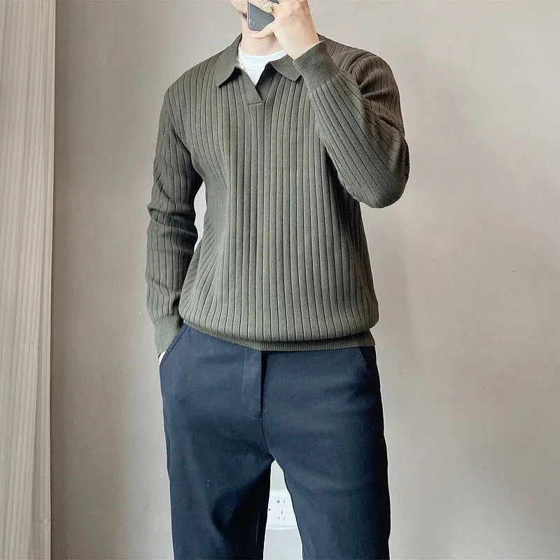 Man wearing a black and white striped knitted jumper with a lapel collar.