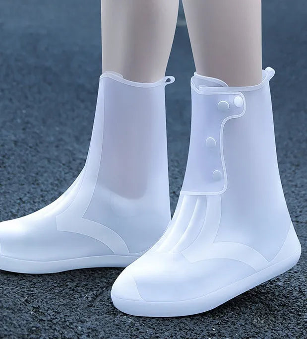 White PVC high top reusable water resistant shoe covers shown on a shoe.