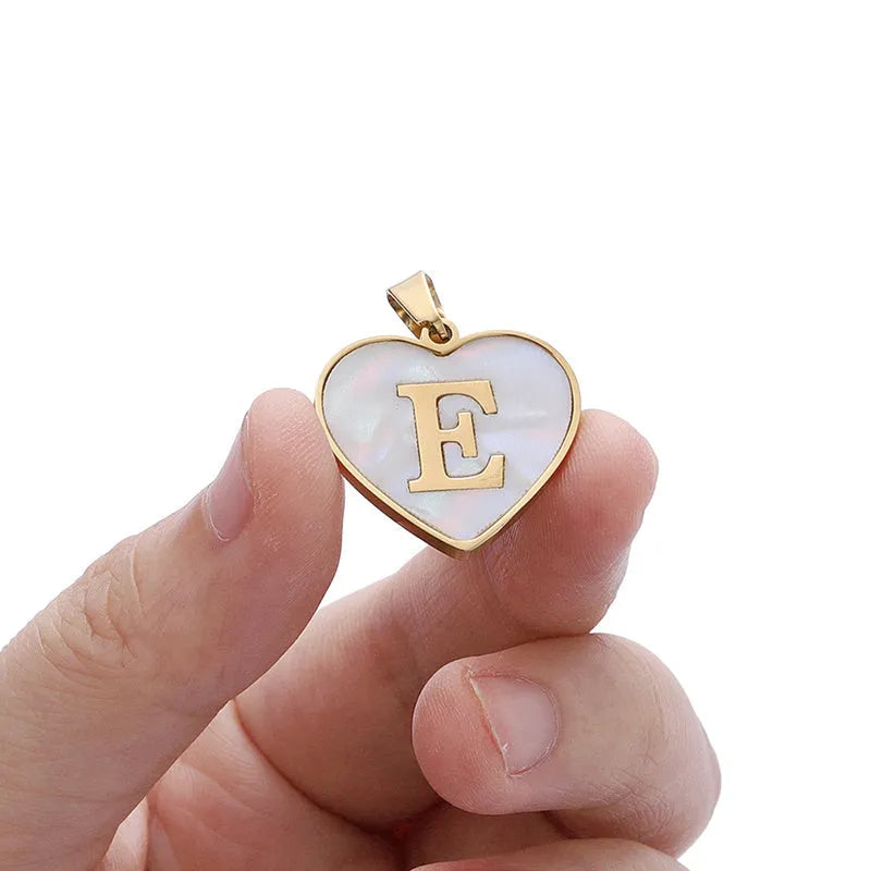 Gold-plated heart-shaped white shell pendant necklace on a stainless steel chain with extendable clasp