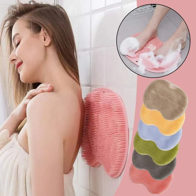 Orange silicone bristle massage bath brush with suction cup bottom on bathroom floor