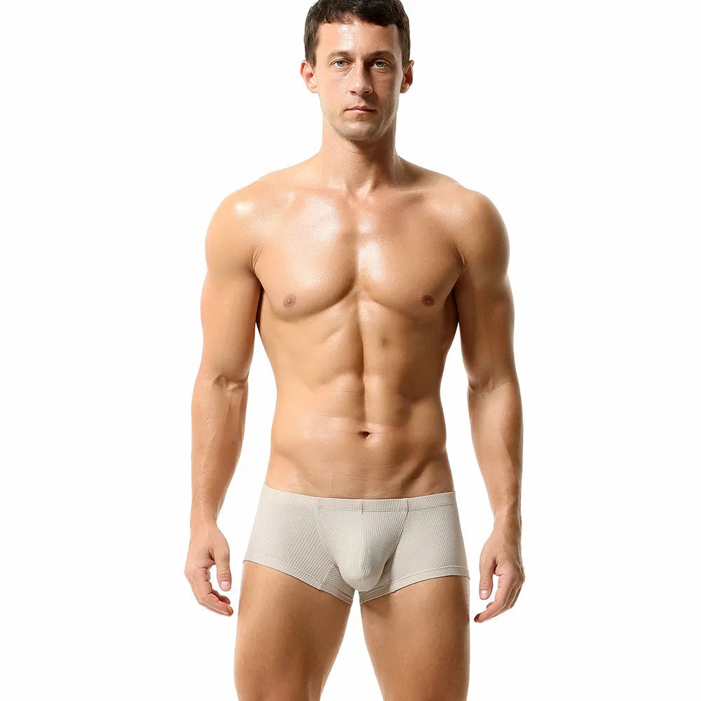 Men's low waist nylon boxer shorts in solid colours orange, blue, green, and white on a size chart.