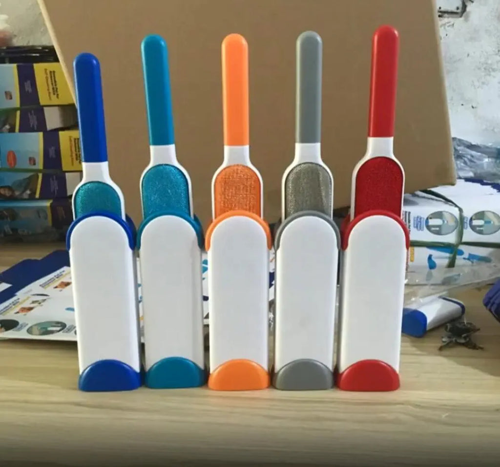 Blue reusable pet hair brush with self-cleaning base for sofas and furniture.