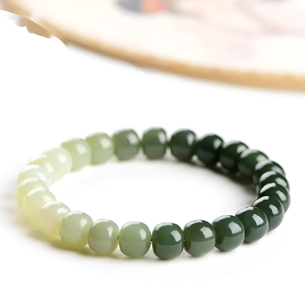 Natural Hetian jade water gradient bracelet with polished beads on an adjustable cord.