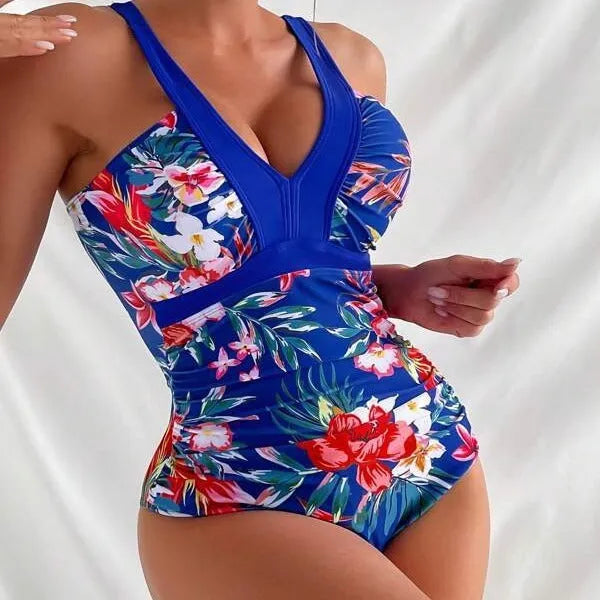 Women's floral patterned backless one-piece swimsuit on a mannequin.