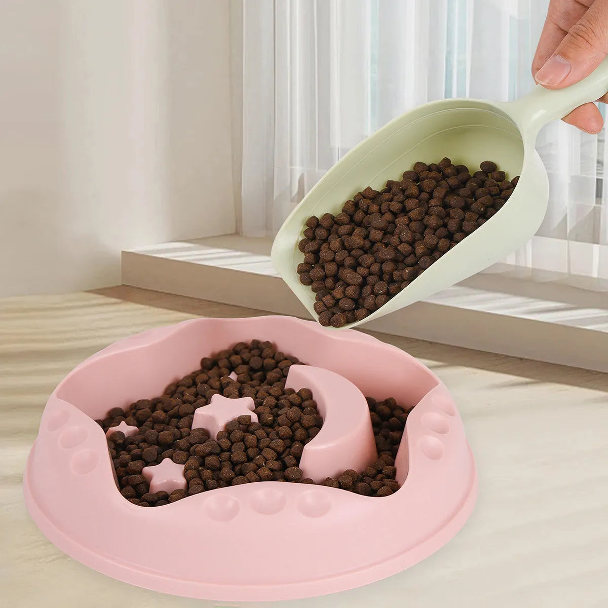 Blue plastic slow feeder dog bowl with moon, star, and wing-shaped interior ridges