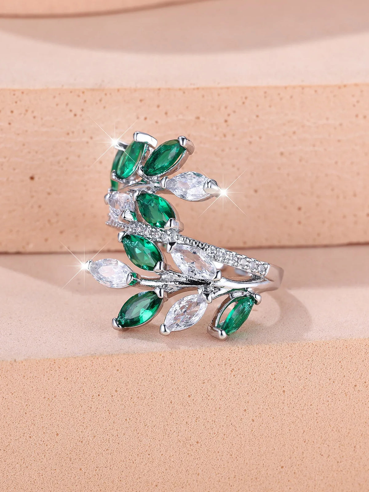 Adjustable horse eye zircon leaf ring in rose gold or platinum plating on a model's hand.