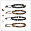 Matte black tiger eye agate couple bracelets with geometric beads on a neutral background.