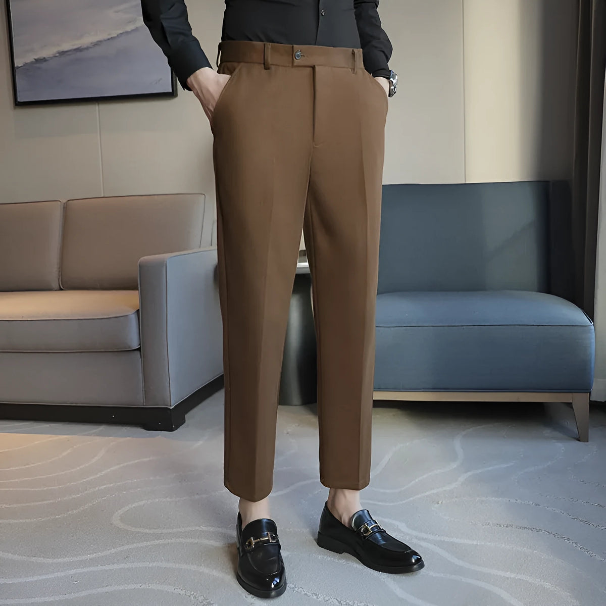 Straight leg brown corduroy trousers for men laid flat, showing texture and elastic waistband.