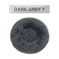 Fluffy donut-shaped dog bed in long plush material, showing raised rim and central cushion.