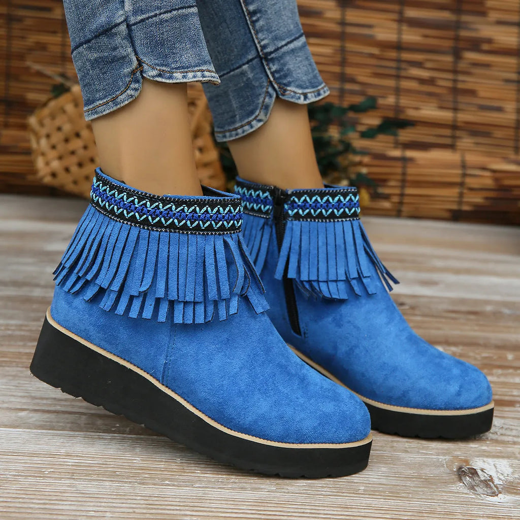 Women's dark brown suede ankle boots with thick platform wedge sole, side zip, and tassel detail.