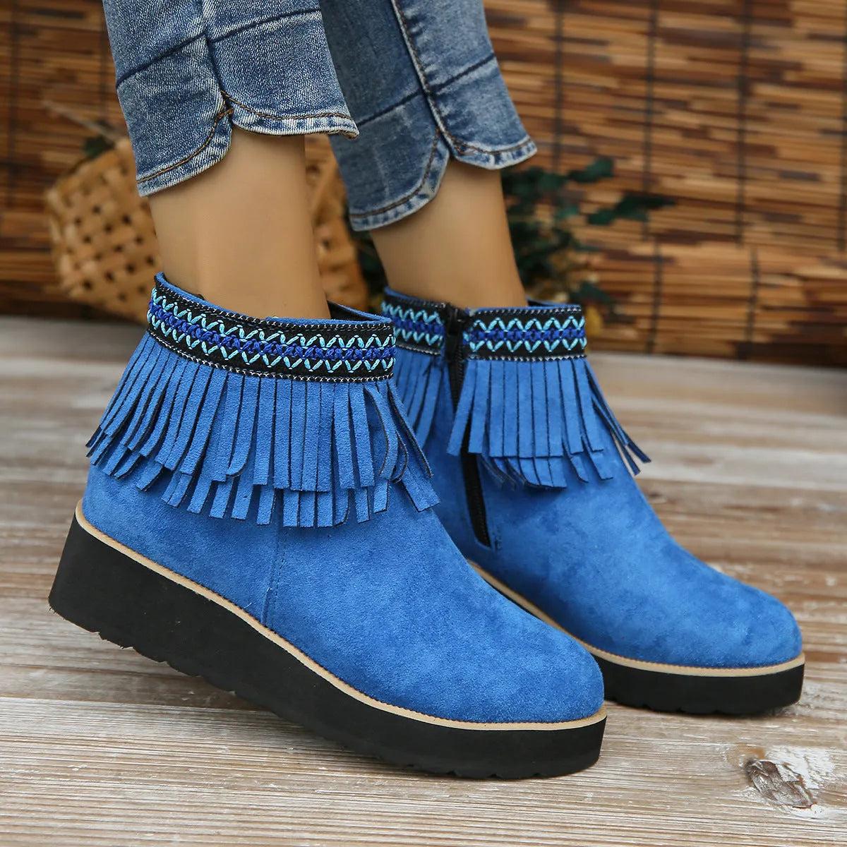 Women's dark brown suede ankle boots with thick platform wedge sole, side zip, and tassel detail.