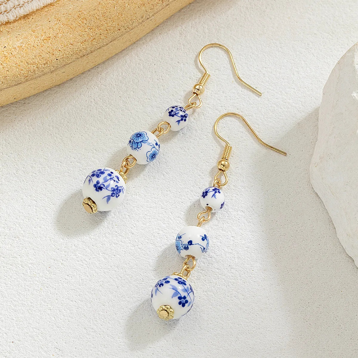 Long blue and white porcelain ceramic bead earrings with geometric Chinese-style design.