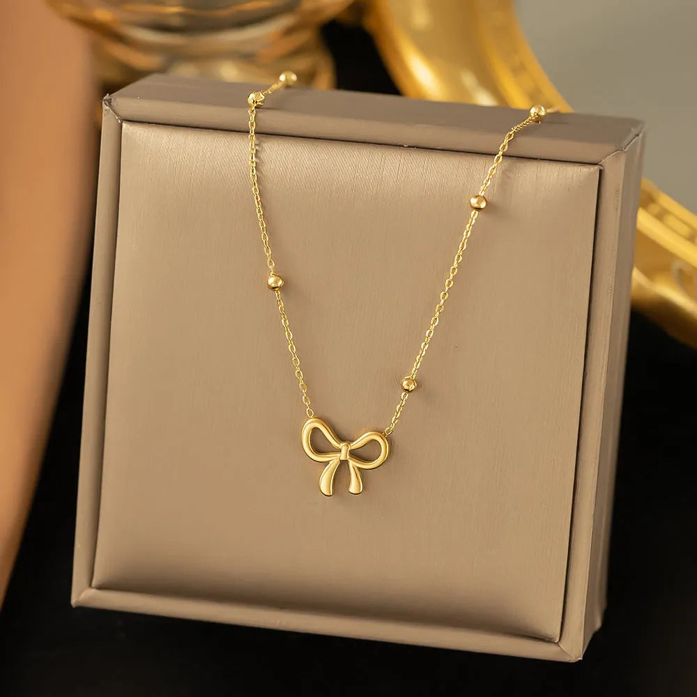 Gold bow necklace on cross chain with adjustable 41-50cm length