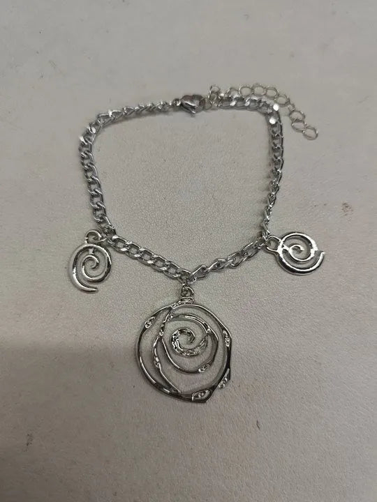 Gold or silver electroplated alloy jewellery set with spiral donut geometric shapes including necklace bracelet and ear hooks
