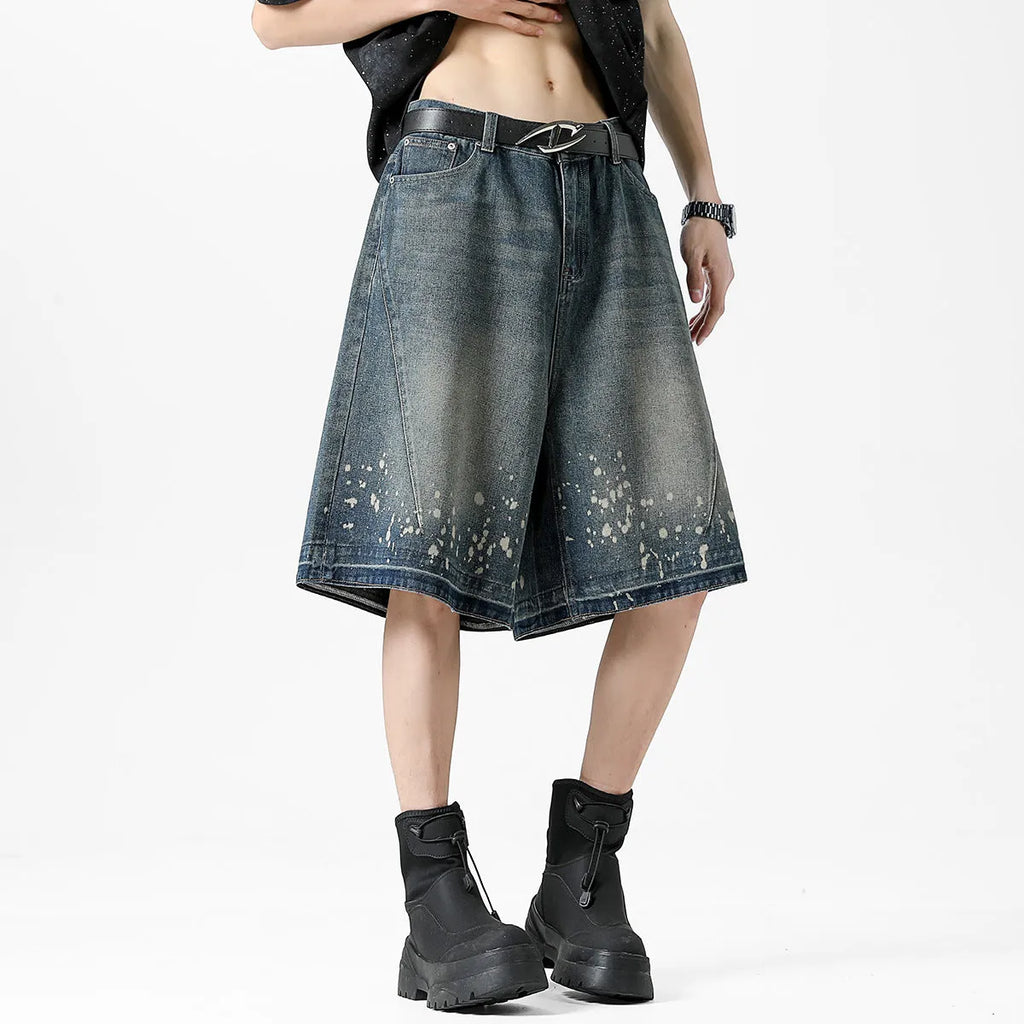 Retro blue washed denim shorts for men with ripped splash ink details and a straight leg cut.