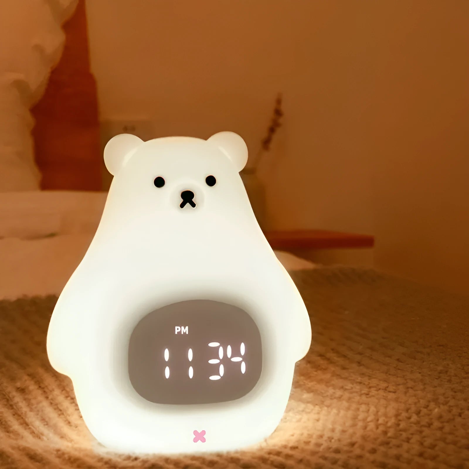 Big white bear shaped silicone night light with remote control on a table.