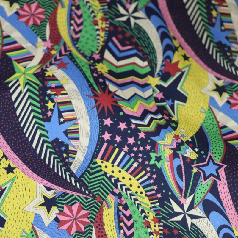 Blue cotton fabric with digital floral printing showing plant designs