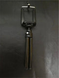 Black desktop phone holder with a two-section adjustable bracket arm holding a mobile phone.