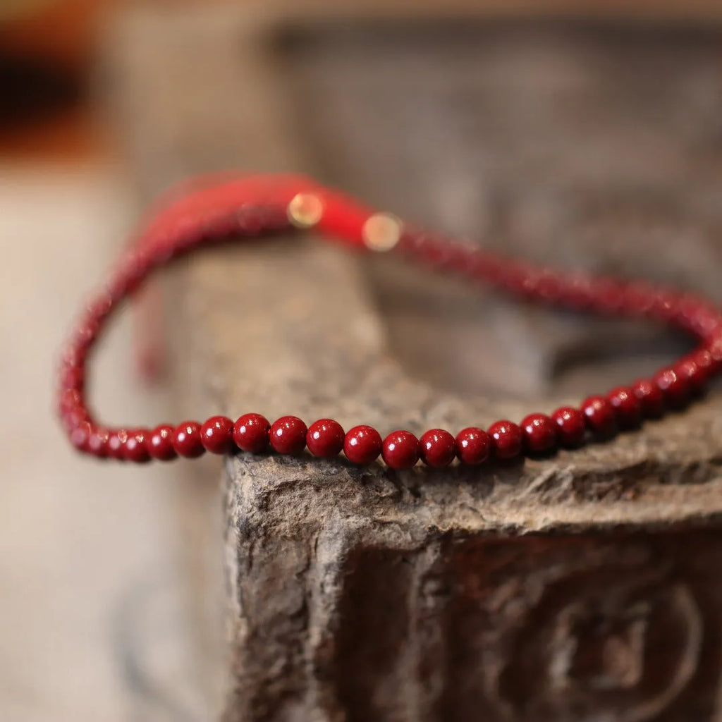 Close-up of a purple gold sand design cinnabar bracelet with geometric Chinese patterns.