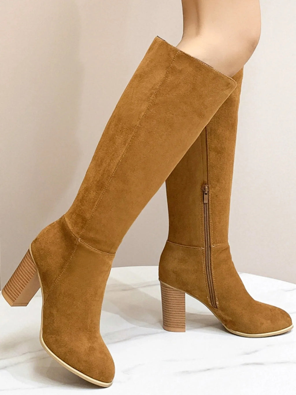 Black square toe high heel fashion boots for women on a white background.