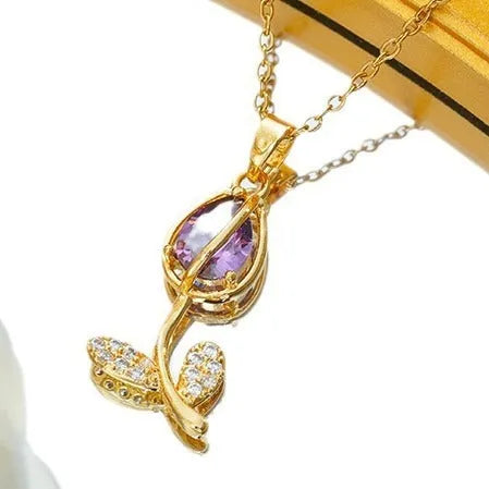 Gold coloured titanium steel necklace with a detailed zircon tulip flower pendant on an O-ring chain.