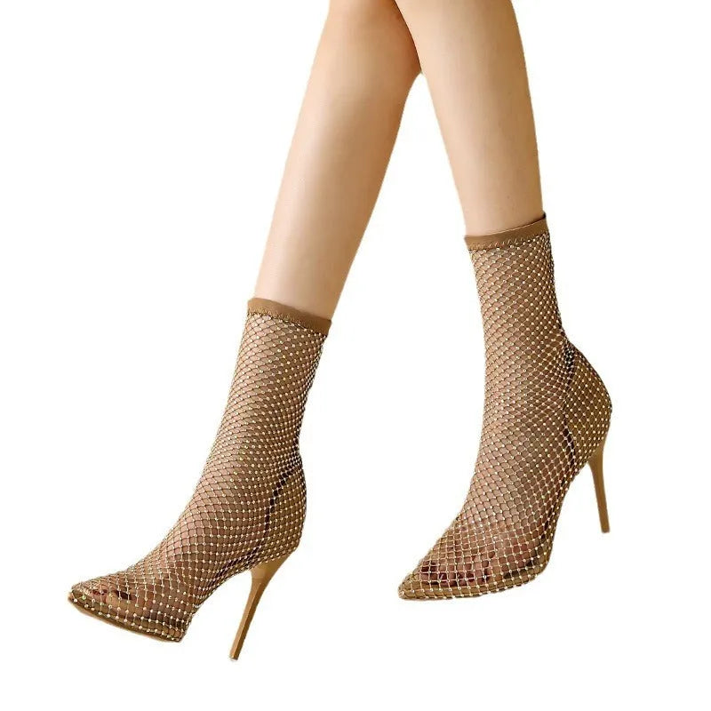 Gold mesh high heel sandals with pointed toes and stiletto heels on a rubber sole.