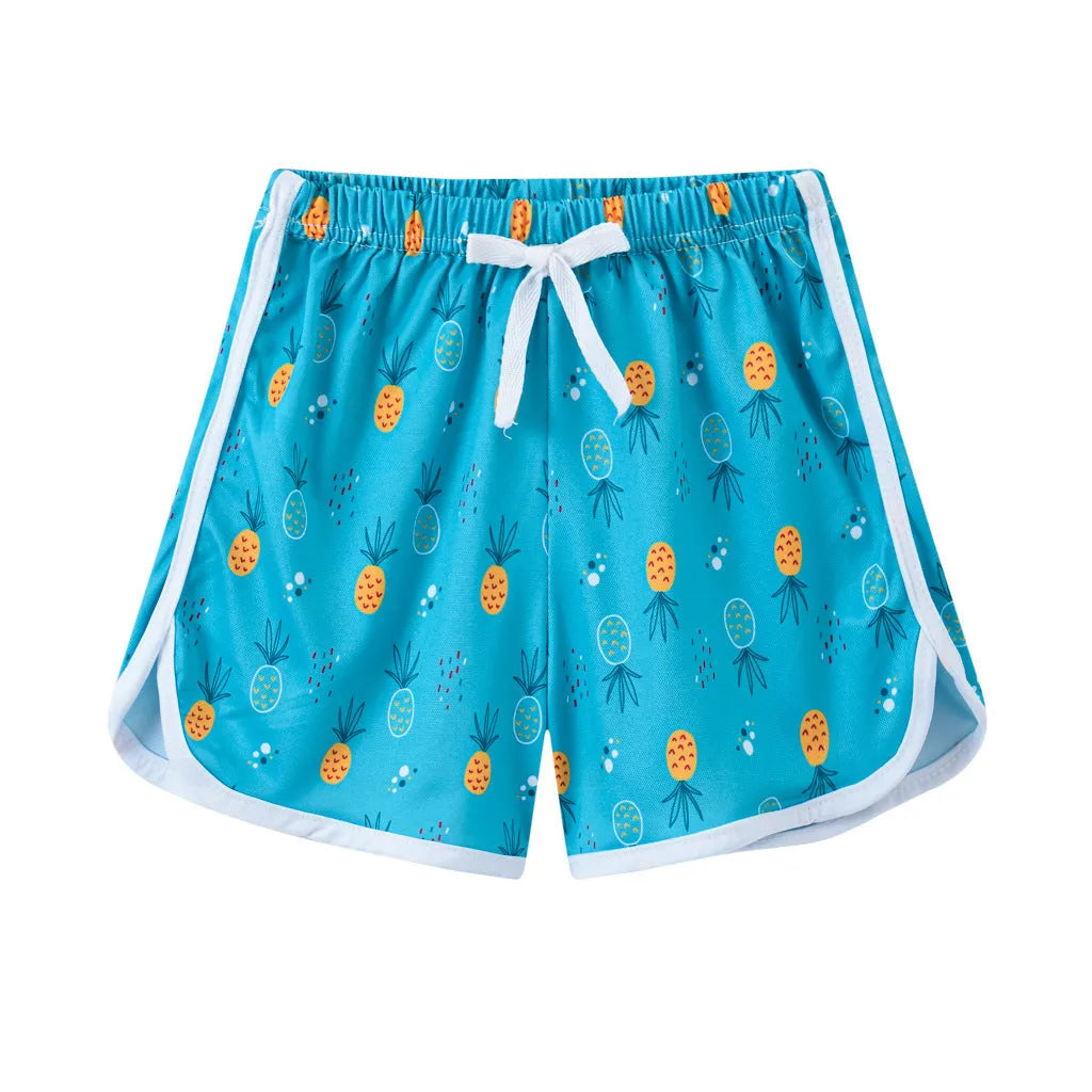 Children's colourful polyester beach shorts showing patterns like leopard print, stripes, and pineapples.