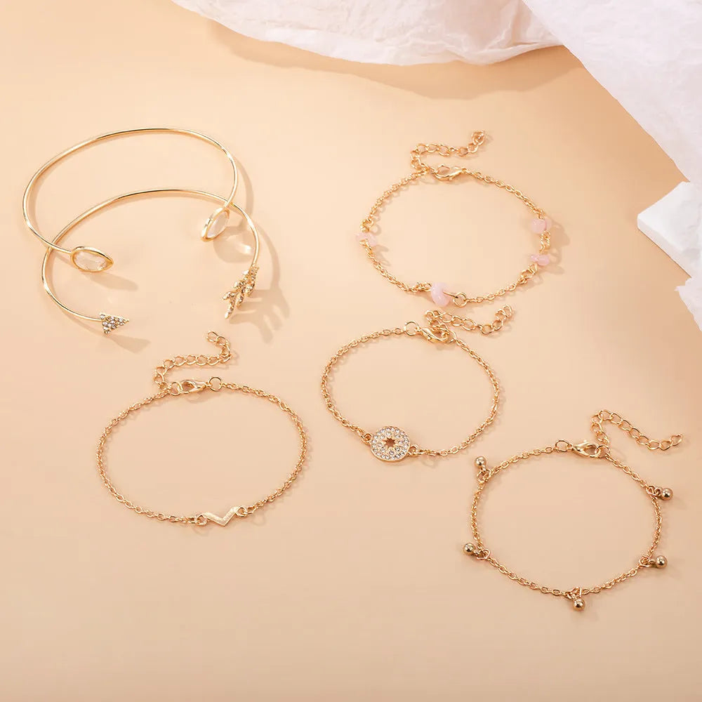 Golden spot finish zinc alloy bracelet set with six pieces featuring arrow, water drop and V-shaped geometric designs