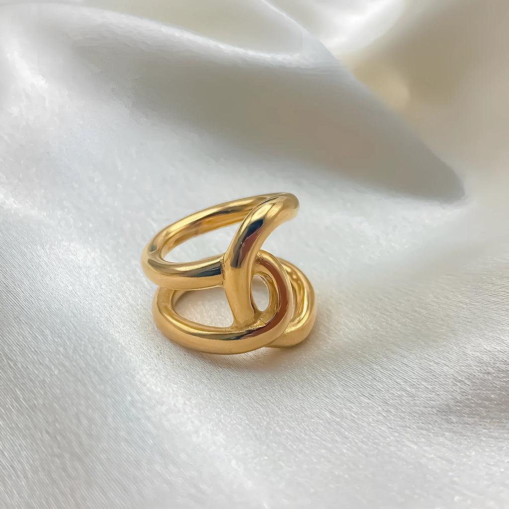 Adjustable stainless steel women's ring with geometric knot design on a U-shaped open band.